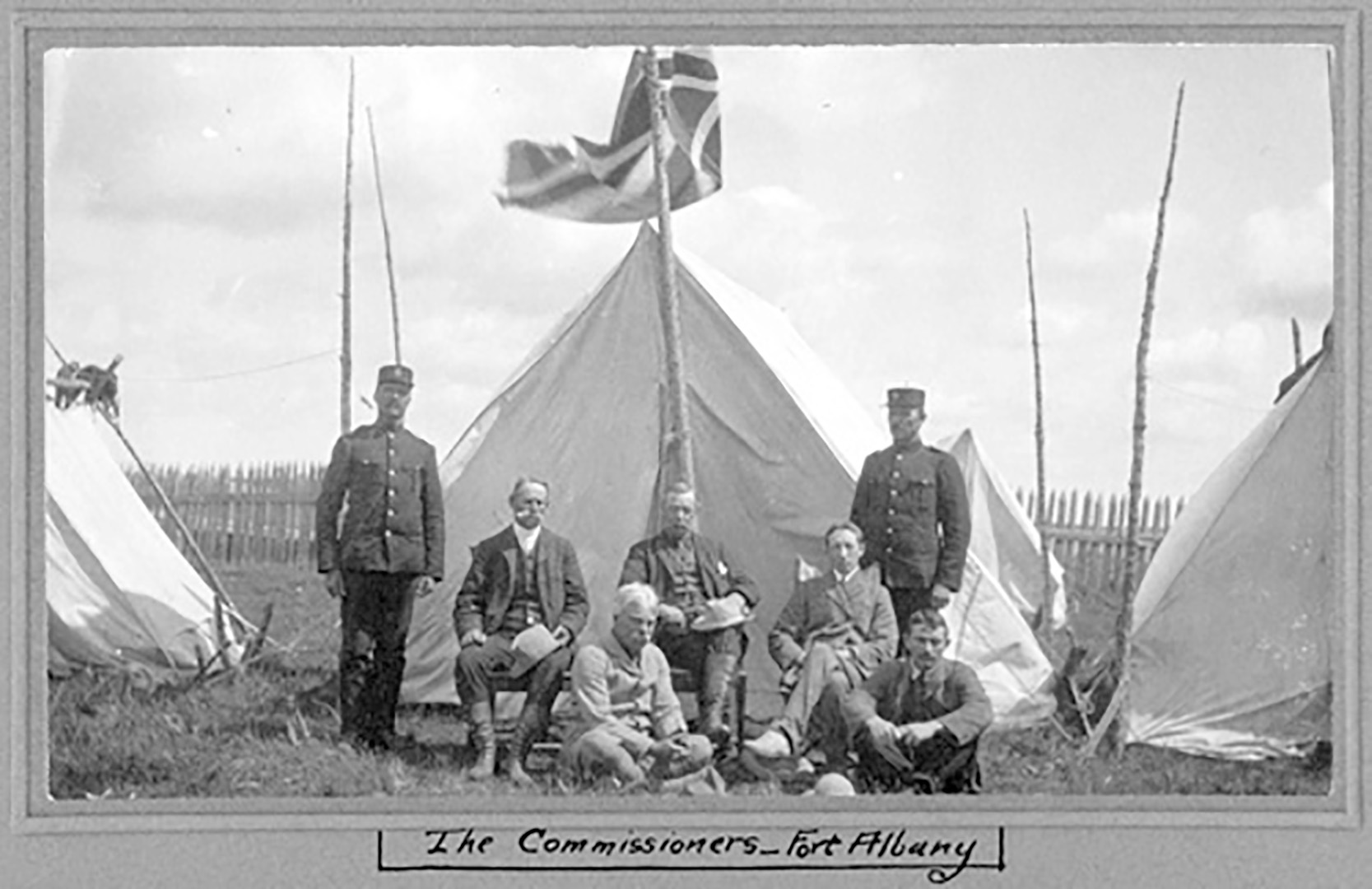 The James Bay Treaty commissioner team at Fort Albany Post, August 3, 1905. Seated: Commissioners Samuel Stewart (L), Daniel G. MacMartin (C), Duncan Campbell Scott (R).