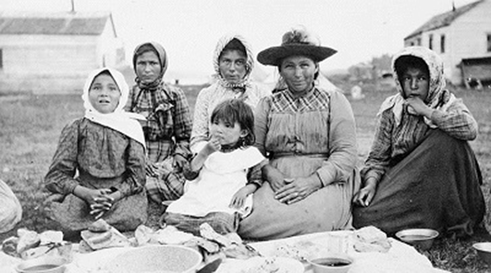 Women and children at a feast at Fort Metagami  during the Treaty 9 payment ceremony in 1905.